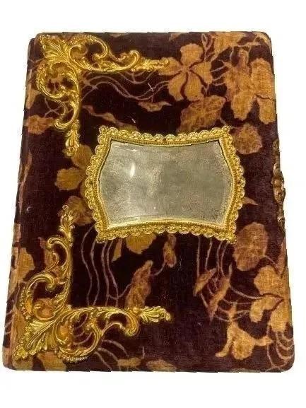 Antique Photo Album: Antique Photo Album measuring 9 inches wide by 12 inches long with a unique up & down clasp. No photos inside and just an empty album from the Victorian era. Decorated with a small mirror on the front