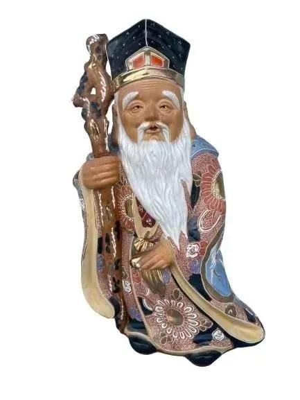 Asian glazed porcelain statue of an old wise man: Asian glazed porcelain statue of an old wise man measuring 14 inches tall.