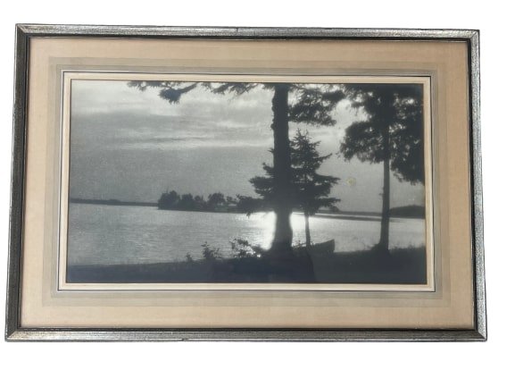 A large old black & white Photograph: A large old black & white photograph of a lake view.Sight measurements are 10 3/4 inches wide by 19 1/4 inches long. The glass covered frame measures 17 inches wide by 25 1/2 inches long.