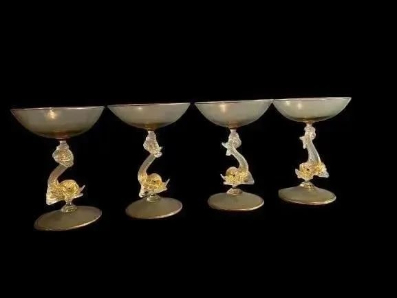 A set of 4 Salviati Venetian Glass Dolphin Wine Goblets: A SET OF FOUR ITALIAN Salviati Venetian Glass Dolphin champagne & Wine Goblets, Handmade very fine glass work. Bowl on a stylized scrolling tailed dolphin modeled stem and swirling circular foot.Salvi