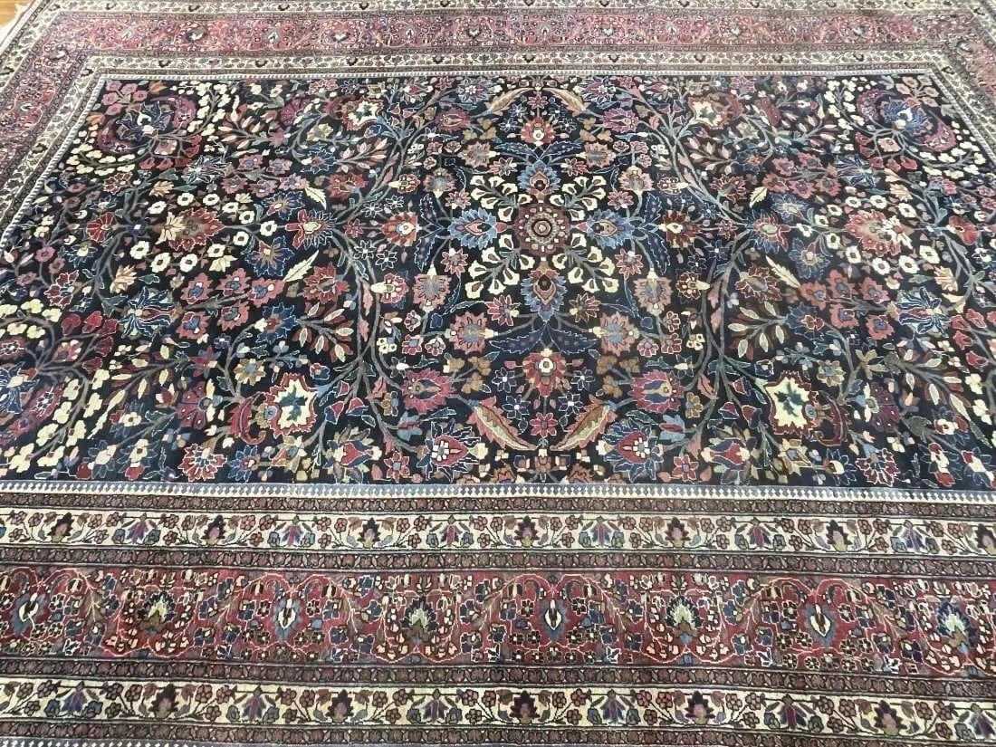 Antique Persian Oversize Mashhad Carpet: Antique Persian Oversize Mashhad Carpet from an Important Southern Estate. A genuine hand woven wool on cotton rug measuring 11 feet 6 inches wide by 17 feet long.