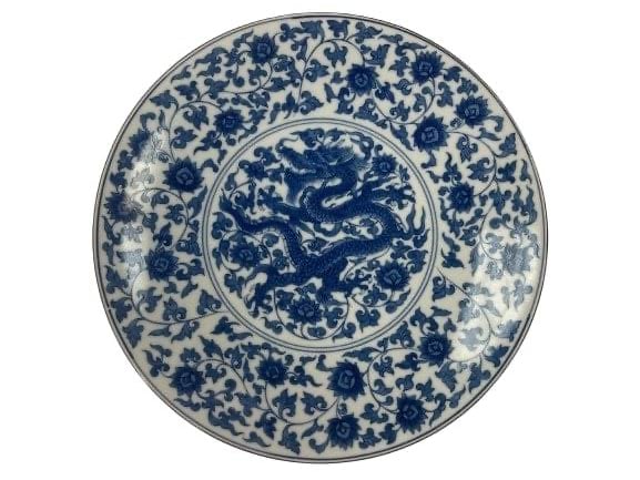 Asian porcelain blue & white dragon charger plate: Asian porcelain blue & white dragon charger plate measuring 12 inches in diameter.