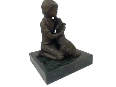 A POM bronze statue of a boy and a dog