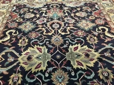 A handwoven Indian Heriz wool rug