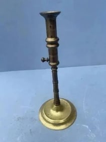 A Brass Candlestick with ejector