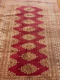A handwoven Pakistan scatter Bokara rug