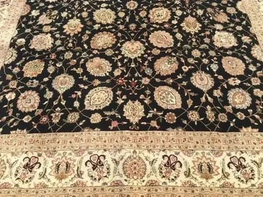 A handwoven Tabriz design rug