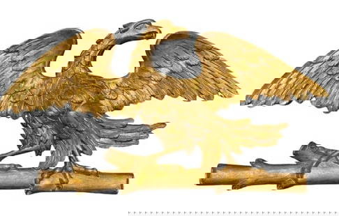 A Hand carved gilted Eagle with a wide wing span: A Hand carved gilted Eagle with a wide wing span measuring 20 inches tall by 37 inches long. A finely carved American Eagle sitting on a tree branch.