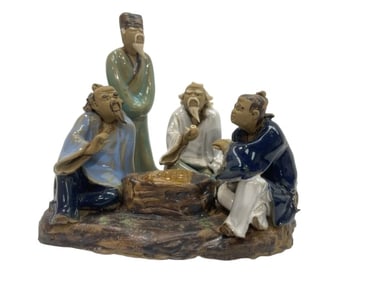 A Chinese glazed stoneware figurine statue of four old men playing Mahjong