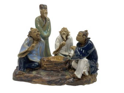 A Chinese glazed stoneware figurine statue of four old men playing Mahjong: A Chinese glazed stoneware figurine statue of four old men playing Mahjong game board. A small highly detailed hand made glazed statue.Measuring about 4 inches tall and 4 inches wide.
