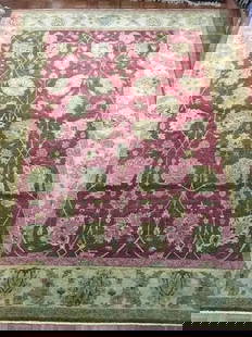 A handwoven Indian Agra wool Rug: A hand woven Indian Agra rug Measuring 9 ft wide by 12 ft 1 inches long.