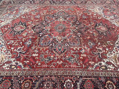 Antique large Persian Heriz hand woven rug 10 ft by 13 ft 6: Antique large Persian Heriz hand woven rug measuring 10 ft wide by 13 ft 6 inches long. A wool genuine Persian Heriz rug from the Northwest Persia. Unique geometric design on a rust field.