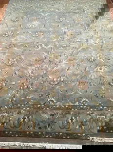 A handwoven Indian Agra wool Rug: A hand woven Indian Agra wool Rug. Measuring 9 ft wide by 12 ft long.