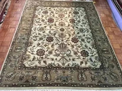 A handwoven Indian Kashan wool Rug: A hand woven Indian Kashan wool rug. Measuring 7 ft 11 inches wide by 10 feet long.