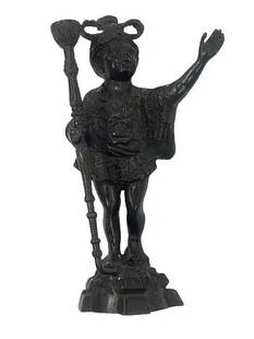 A French Bronze Blackamoor D'ore Candle holder statue: A French Bronze Blackamoor D'ore Candle holder statue standing 15 inches tall. A solid bronze decorative statue.