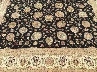 A handwoven Tabriz design rug