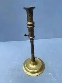 A Brass Candlestick with ejector