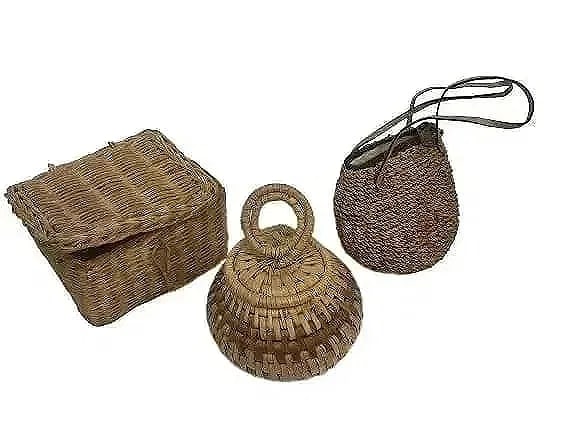A group of three woven baskets: A group of three willow woven baskets items. one woven purse with two woven baskets.