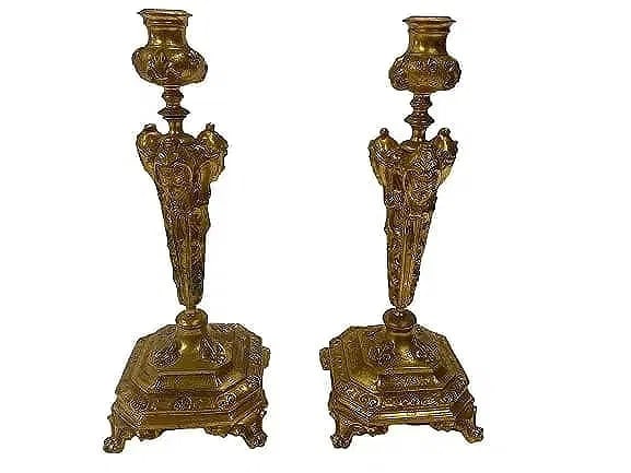 A Pair of French Gilt bronze candle holders: A Pair of French Gilt bronze candle holders standing Inches tall. A unique French triple empire female faces with fleur-de-lis pattern in the base casting.