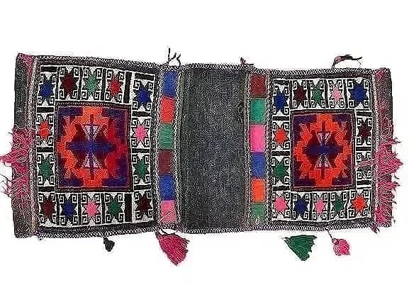 A Balouch hand woven Saddle bag: An old Afghan Balouch hand woven Saddle bag measuring 36 inches long by 15 inches long.