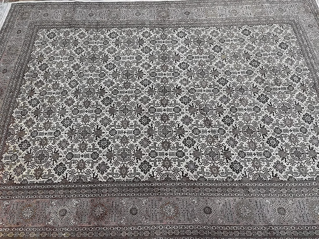 A Persian Tabriz rug: A Persian Tabriz rug measuring 6 feet 3 inches wide by 9 feet 3 inches long. A finely woven wool on cotton Persian rug with a Caucasian Kuba Afshan design.