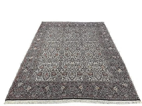 A Persian Bijar hand woven wool rug: A Persian Bijar hand woven wool rug measuring 6 feet 8 inches by 8 feet 4 inches long. A finely woven Genuine Persian Kurdish Bijar wool rug. A highly intricate floral all over design.