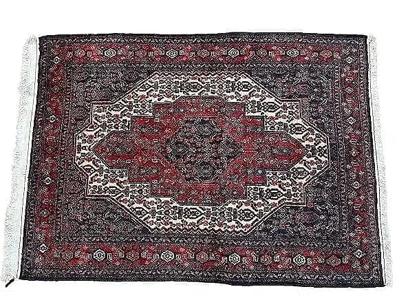 A Persian Kurdish Senneh wool scatter rug: A Persian Kurdish Senneh wool scatter rug measuring 47 inches wide by 65 inches long. A finely woven tribal hand knotted single wefted weaving Persian Senneh rug.