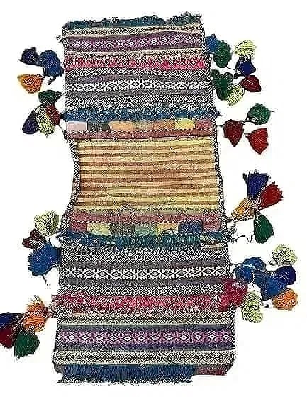 A Balouch hand woven Saddle bag: An old Afghan Balouch hand woven Saddle bag measuring 34 inches long by 15 inches long.