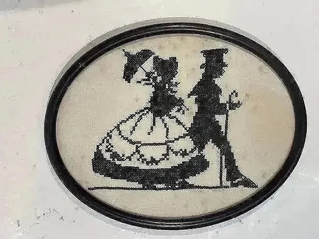 Antique American Needlepoint Embroidery of a man & woman: Antique American Needlepoint Embroidery of a man & woman on a stroll .Oval shape framed measuring 8 inches by 10 inches wide.