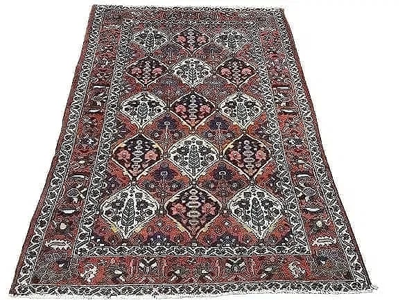 Antique Persian Bakhtiari rug: Antique Persian Bakhtiari measuring 4 feet 11 inches wide by 6 feet 11 inches long. A Tribal panel design with cyprus trees and flowers border system. A colorfull design wool on cotton hand knotted
