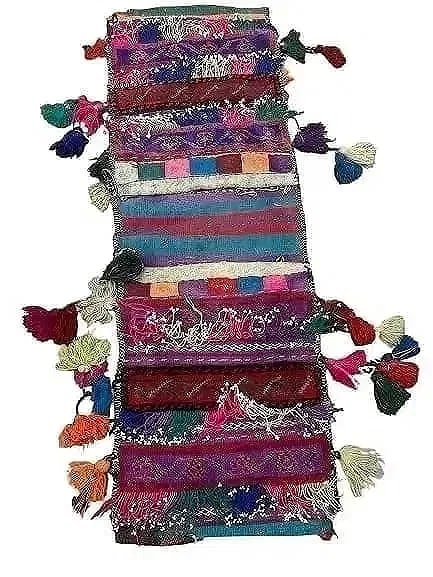 A Balouch hand woven Saddle bag: An old Afghan Balouch hand woven Saddle bag measuring 34 inches long by 12 inches long.