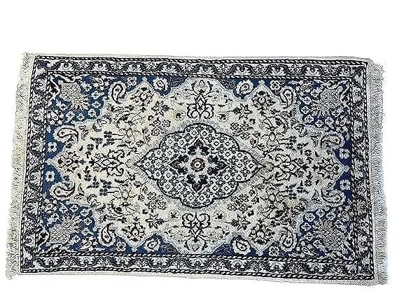 A Persian Nain scatter handwoven rug: A Persian Nain scatter handwoven rug measuring 35 inches wide by 54 inches long.