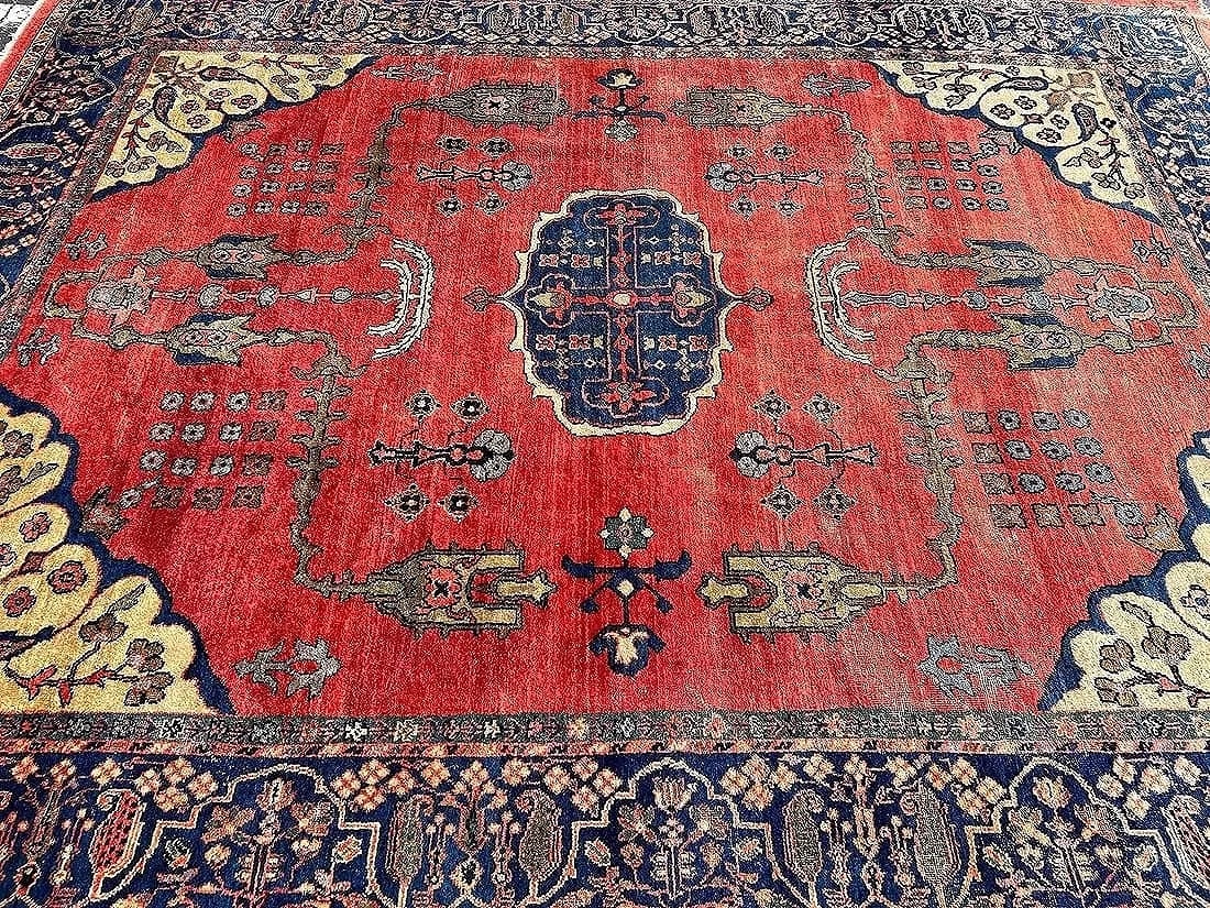 Antique Persian Sultanabad room size rug: Antique Persian Sultanabad room size hand knotted wool rug measuring 9 feet 4 inches wide by 12 feet long. An Unusual spacious cross blue medallion resting on open soft red field flanked by branch &