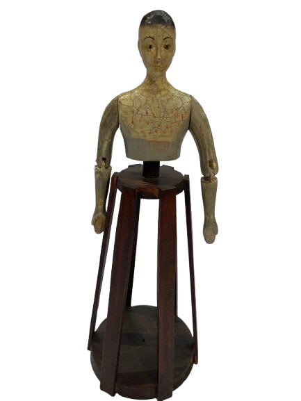 A European Santos Cage type hand carved Doll: A European Santos Cage type hand carved Doll standing about 15 inches tall.A hand carved wooden head & torso with articulating arms for posing resting on a wooden cage base meant to be covered with