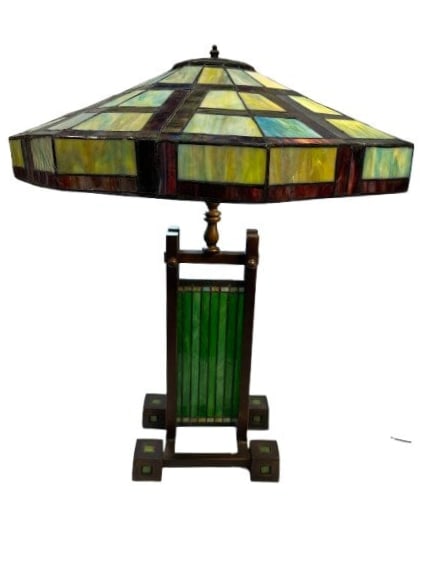 A Frank Lloyd Wright style single column lamp: After Frank Lloyd wright style table lamp with single column bronze base and stained glass shade & base. The Frank Lloyd Wright double pedestal lamp was originally designed for the Dana-Thomas house