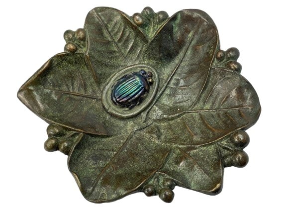 A Tiffany Studios Bronze leaf dish with iridescent scarab Favrille glass: A Tiffany Studios Bronze leaf dish with iridescent scarab Favrille glass. A highly detailed and heavy bronze dish stamped TIFFANY STUDIOS with the Tiffany logo. The Bronze dish measures 6 1/2 inches