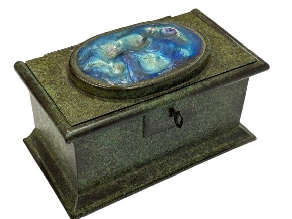 A Tiffany Studios bronze trinket or cigar box with a turtle back iridescent Fevrille glass cover: A large Tiffany Studios bronze trinket or a cigar / cigarette box with a turtle back iridescent Fevrille glass cover and cedar wood lining. A heavy & highly detailed casting bronze box base.Stamped