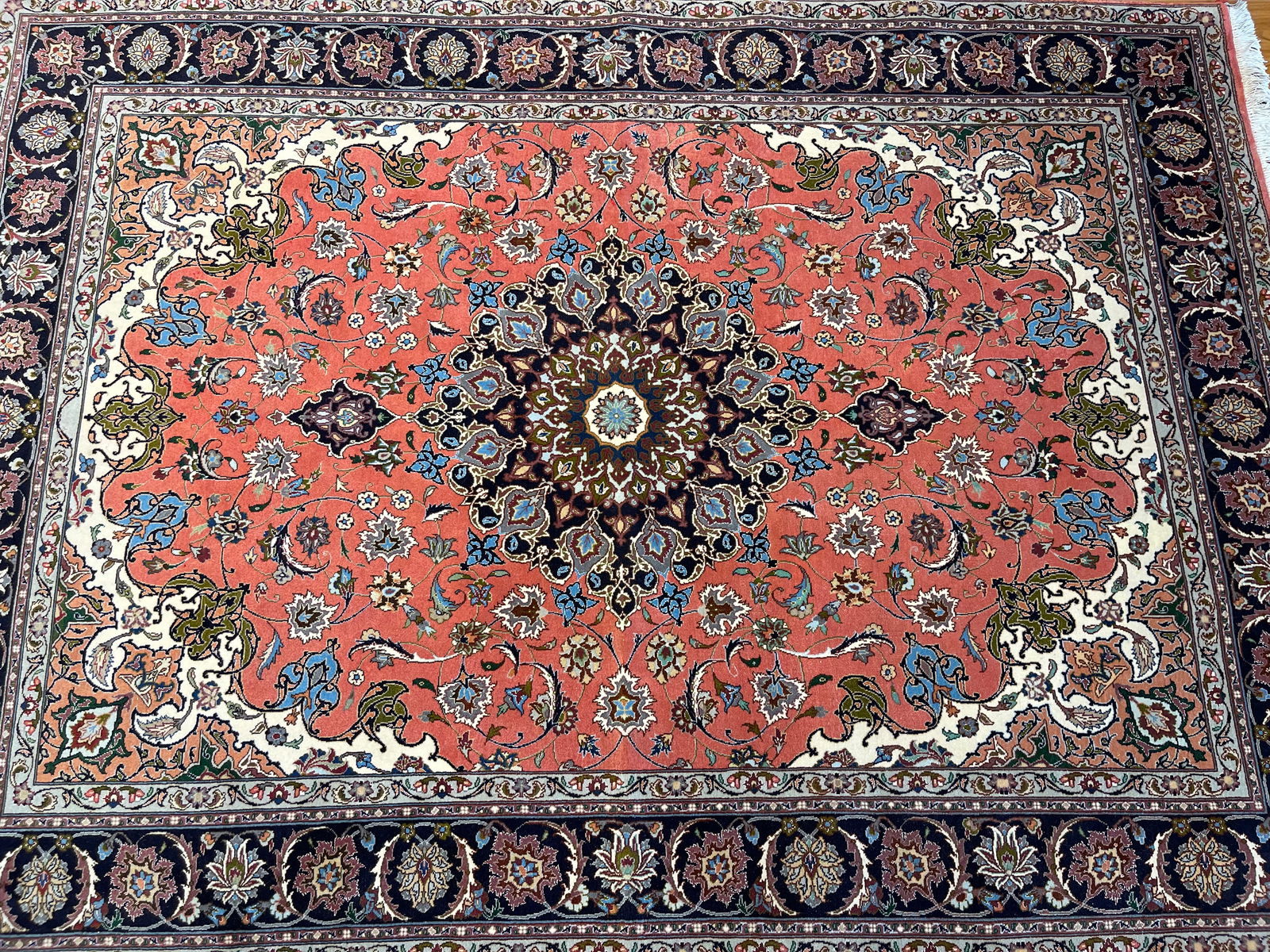 A Persian Tabriz wool & silk rug: A Persian Tabriz wool & silk rug rug measuring 5 feet 1 inches wide by 6 feet 11 inches long. A wool & silk high lighted rug on cotton foundation. A genuine Persian hand knotted fine Tabriz floral des