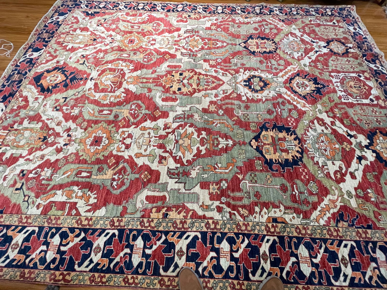 A Pakistan Caucasian Dragon design large Hand woven rug: A Pakistan Caucasian Dragon design large room size Hand woven rug measuring 10 feet 2 inches wide by 13 feet long. A beautiful lustrous hand knotted wool rug with a highly decorative all over design.