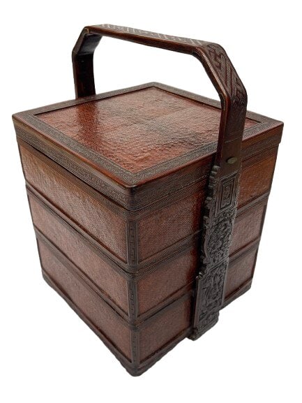 A Chinese wedding stack basket: A Chinese wedding stack basket, traditionally made from carved bamboo, wood, and woven materials. Function: Historically used to transport gifts, food, or dowry items during wedding ceremonies. Struct