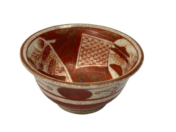 Antique Japanese Kutani ware bowl: Antique Japanese Kutani ware bowl, likely from the Meiji period (1868–1912). Measures 2 3/8 inches in diameter.Style: Features Aka-e (red painting) with gold highlights, often depicting scenes,