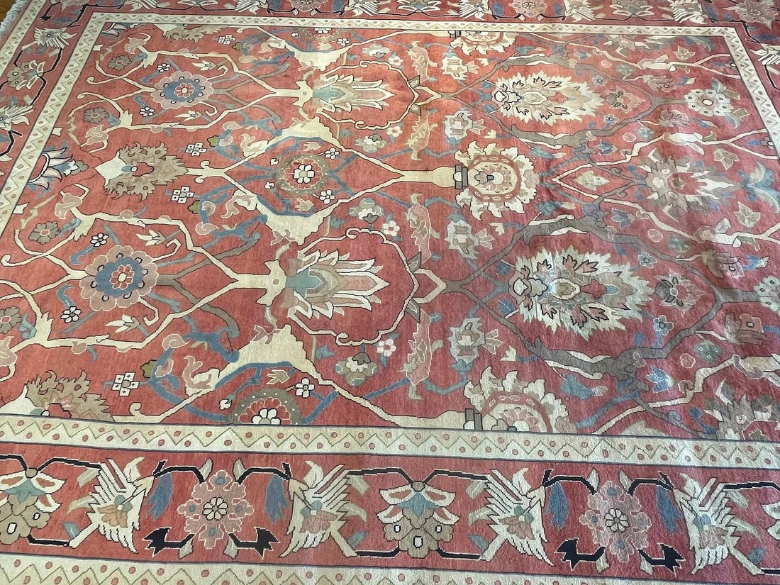 A Persian Tabriz room size rug: A Persian Tabriz room size rug measuring 9 feet 8 inches wide by 12 feet 8 inches long. A genuine handwoven wool Persian all over floral Sultanabad design Tabriz wool rug on a rust color field with iv