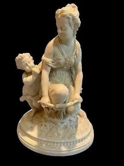 European Bisque porcelain Sculpture: European Bisque porcelain Sculpture of a young woman with a child. Stands 16 inches tall.