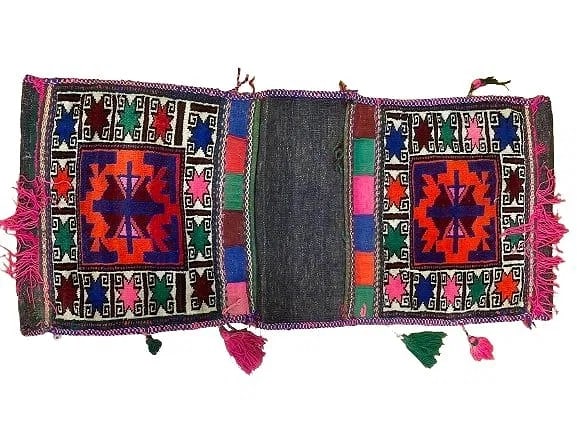 A Balouch hand woven Saddle bag: An old Afghan Balouch hand woven Saddle bag measuring 36 inches long by 15 inches long.