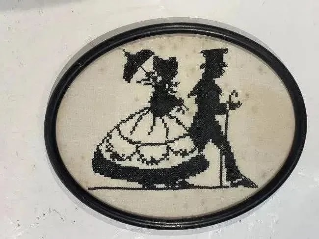 Antique American Needlepoint Embroidery of a man & woman: Antique American Needlepoint Embroidery of a man & woman on a stroll .Oval shape framed measuring 8 inches by 10 inches wide.