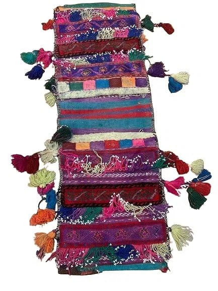 A Balouch hand woven Saddle bag: An old Afghan Balouch hand woven Saddle bag measuring 34 inches long by 12 inches long.