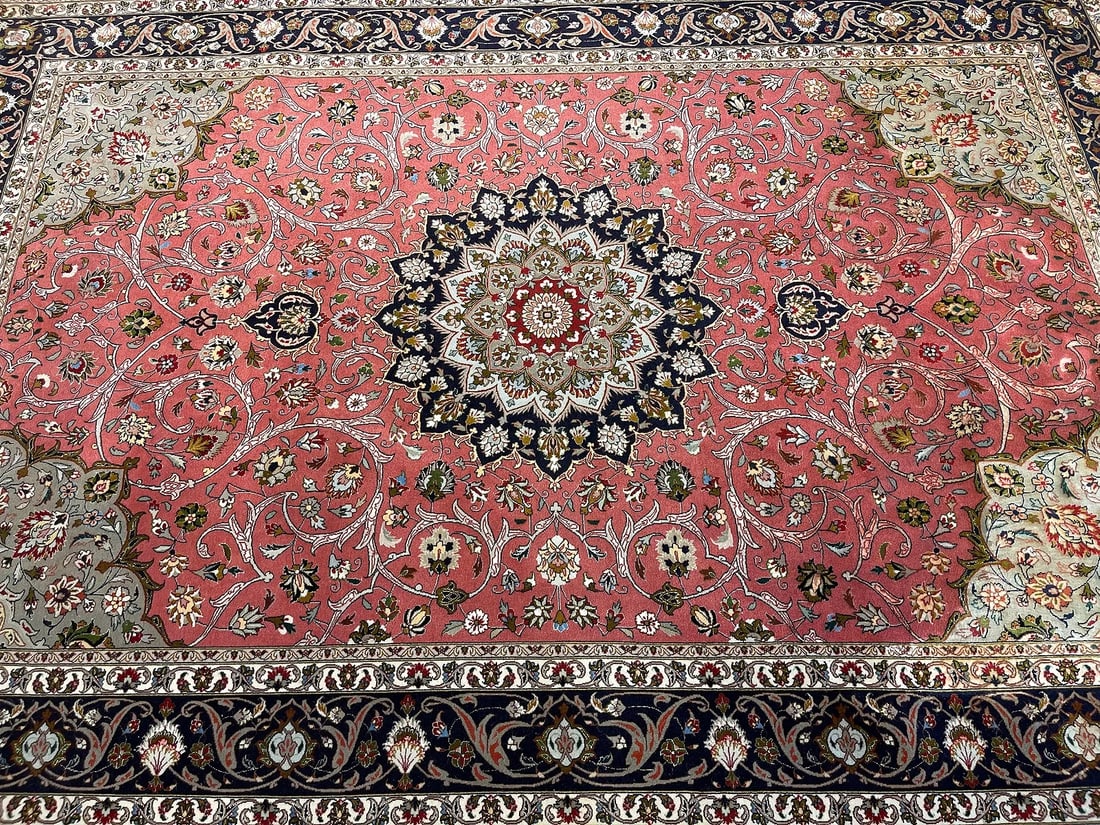 A Persian Tabriz rug with wool & silk highlights: A Persian Tabriz handwoven rug with wool and silk highlights on cotton foundation.A finely woven genuine Persian Tabriz rug measuring 6 feet 8 inches wide by 9 feet 11 inches long.