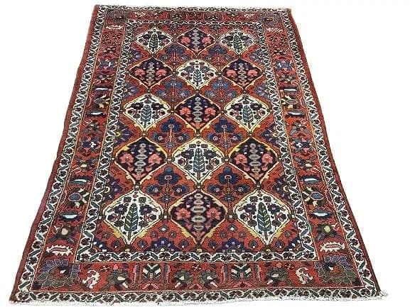 Antique Persian Bakhtiari rug: Antique Persian Bakhtiari measuring 4 feet 11 inches wide by 6 feet 11 inches long. A Tribal panel design with cyprus trees and flowers border system. A colorfull design wool on cotton hand knotted