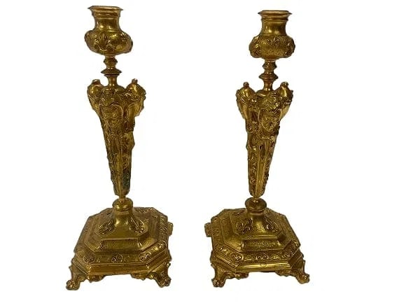 A Pair of French Gilt bronze candle holders: A Pair of French Gilt bronze candle holders standing Inches tall. A unique French triple empire female faces with fleur-de-lis pattern in the base casting.