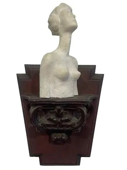 A unique Female Clay Bust on a sconce: Old Female clay bust on a sconce. A unique work by perhaps a follower of Alberto Giacometti. The sculpture measures 7 inches tall with wall hanging sconce pedestal measuring 8 inches tall.